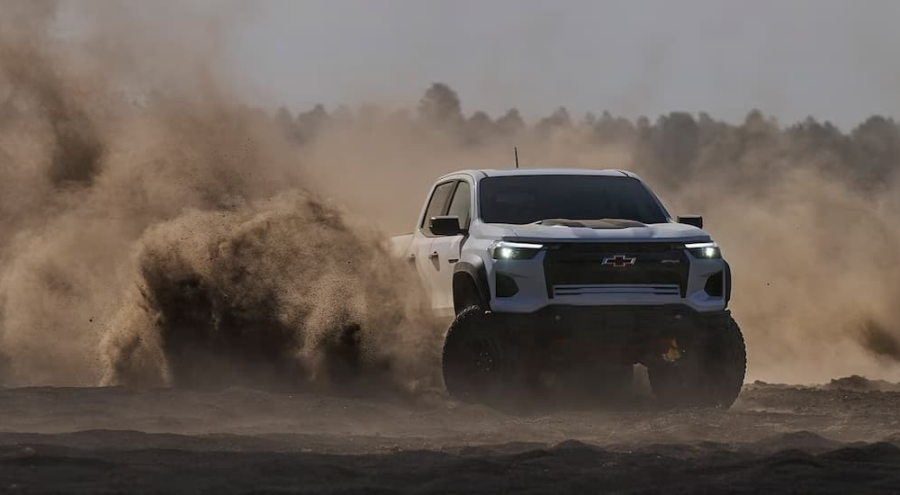 A white 2023 Chevy Colorado ZR2 Bison off-roading after leaving a Chevy dealer.