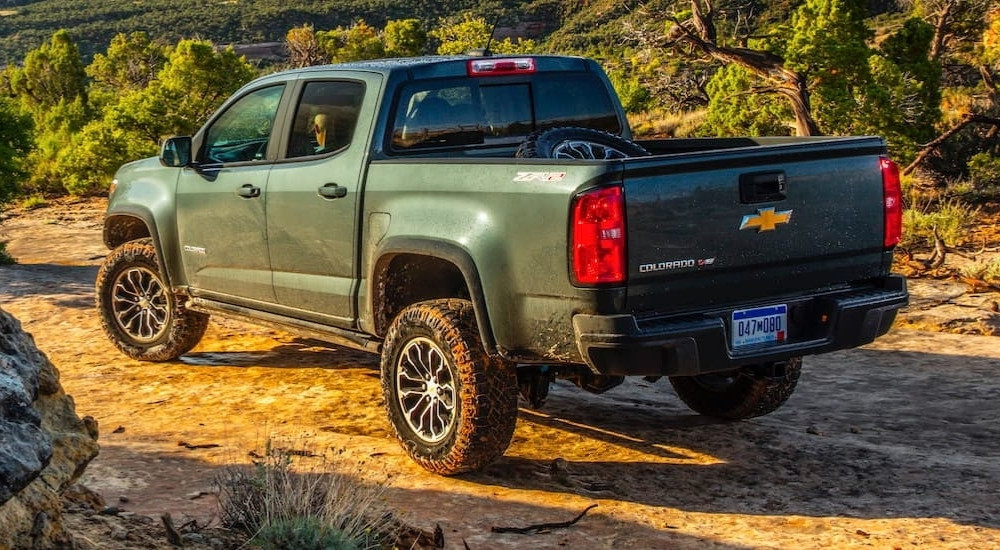 A green 2020 Chevy Colorado parked on a dirt trail after leaving a used Chevy dealership.