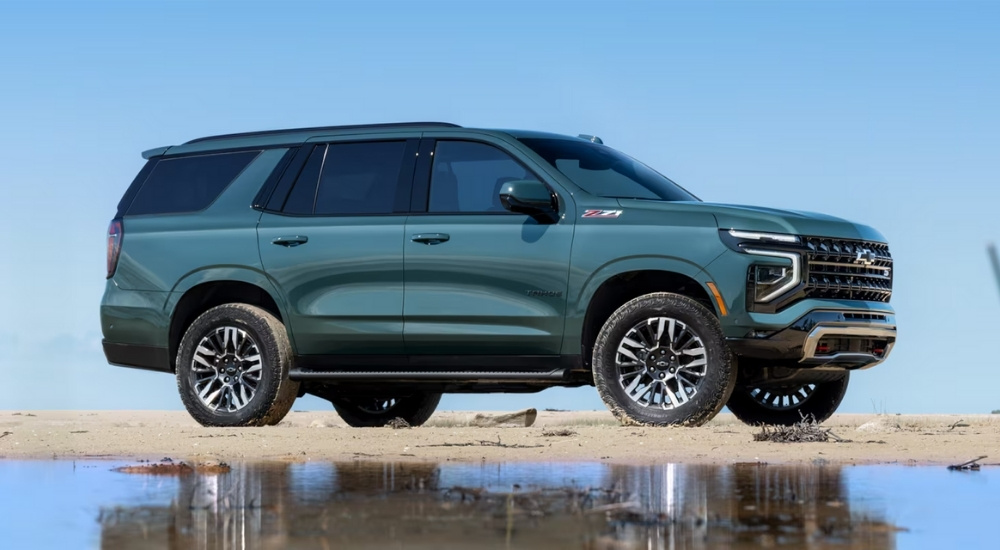 A green 2025 Chevy Tahoe Z71 parked on a shore.
