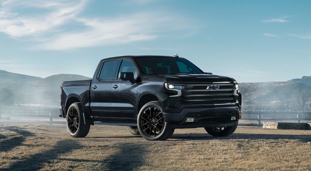 A black 2025 Chevy Silverado 1500 High Country is parked on a farm after leaving a Chevy dealer near Opelousas.