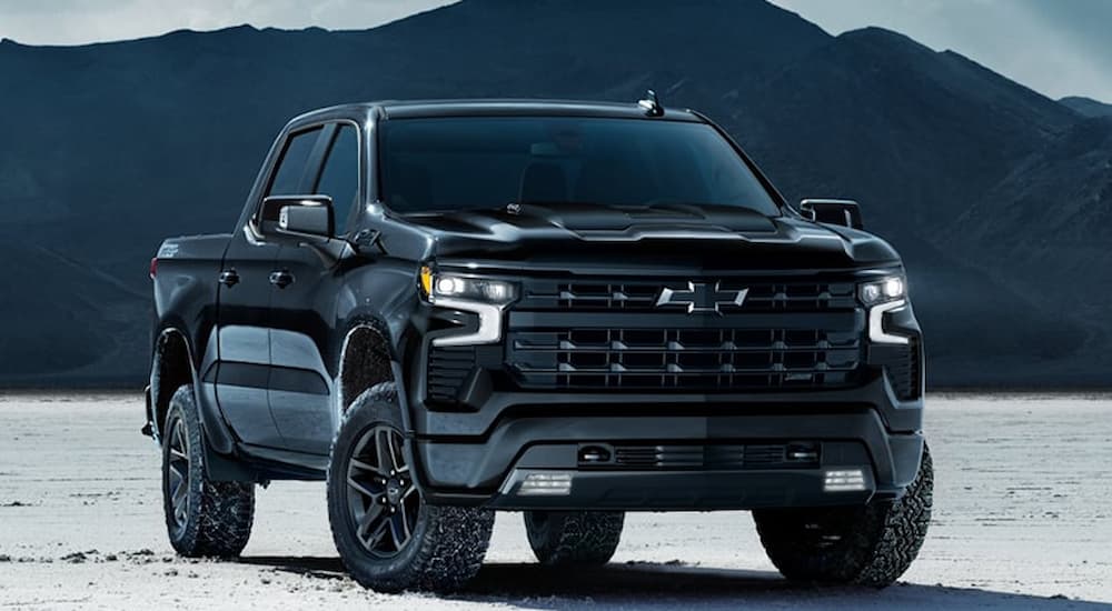Black 2025 Chevy Silverado 1500 for sale in Alexandria parked on sand.
