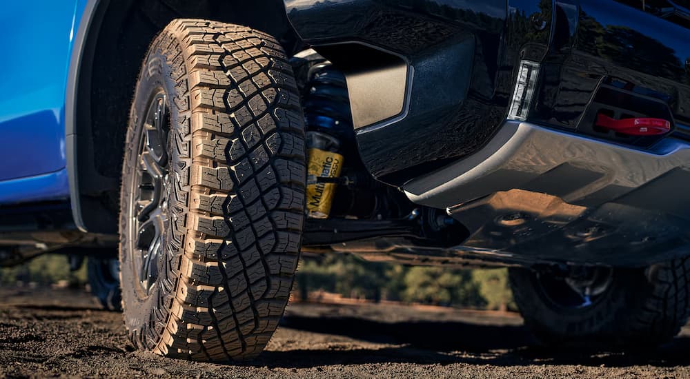 Close-up on the wheel of a blue 2025 Chevy Silverado 1500.