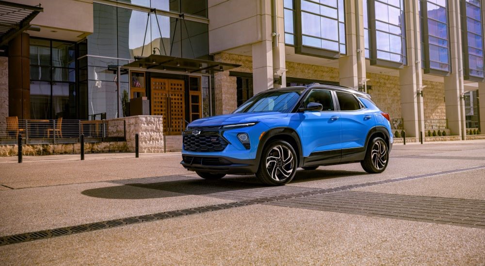 A blue 2024 Chevy Trailblazer RS for sale is parked on a city street.