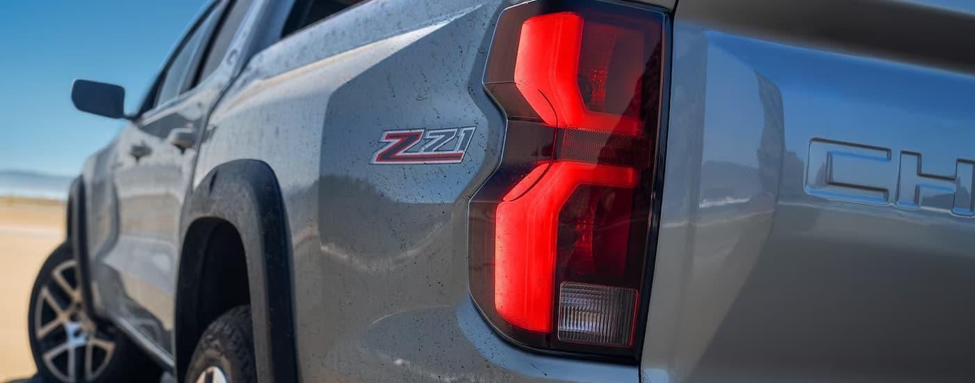 A close up of the side of a grey 2024 Chevy Colorado for sale.