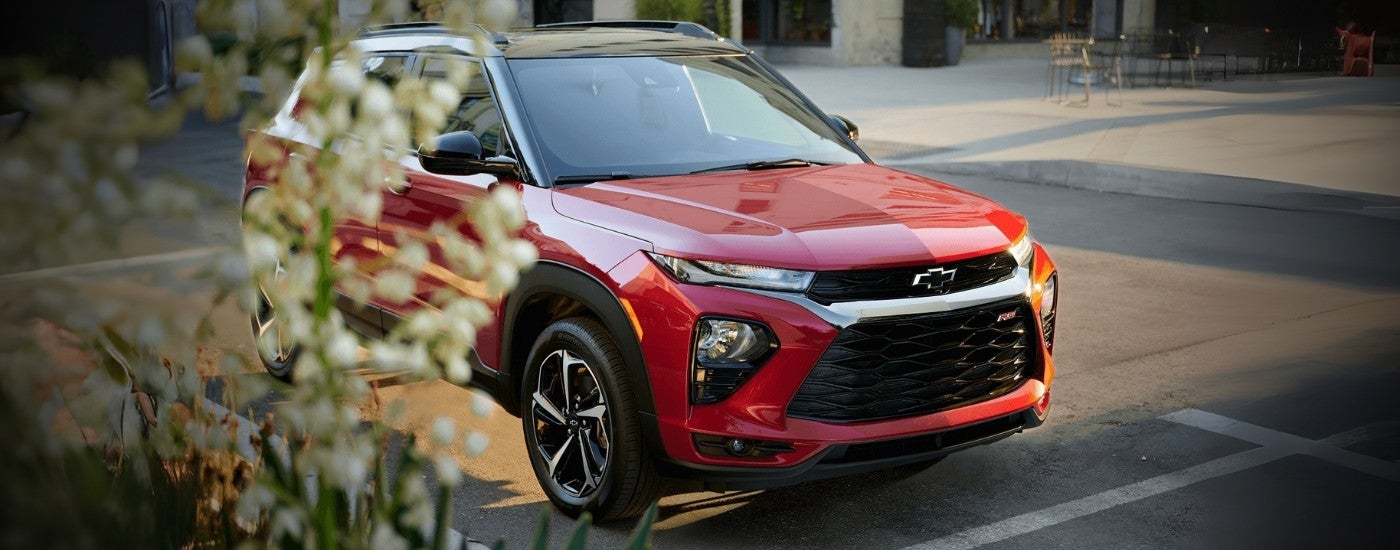 A red 2023 Chevy Trailblazer RS parked on a city street.