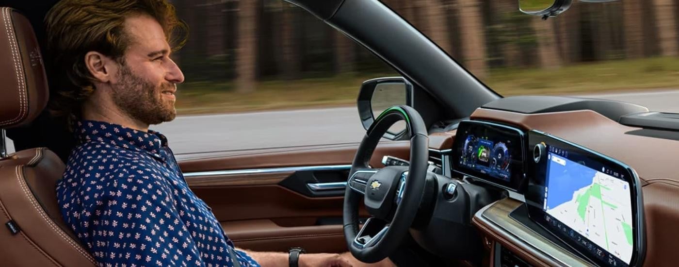 A man is using the Super Cruise feature in a 2025 Chevy Tahoe.