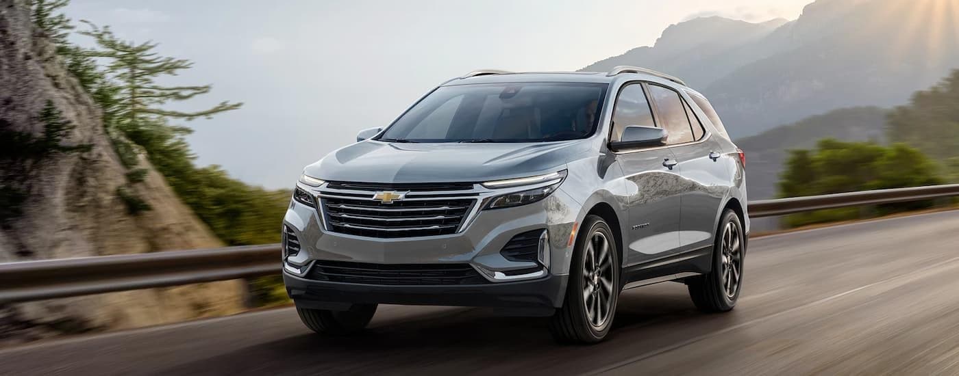 A silver 2024 Chevy Equinox driving on a highway.