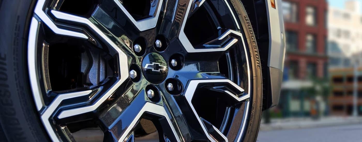 A close up of the black and silver rim on a 2025 Chevy Tahoe RST.