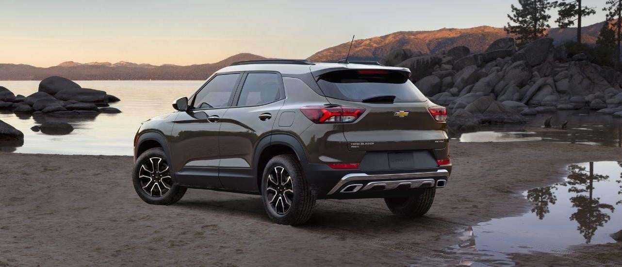  A tan 2021 Chevy Trailblazer ACTIV is shown parked near a lake.