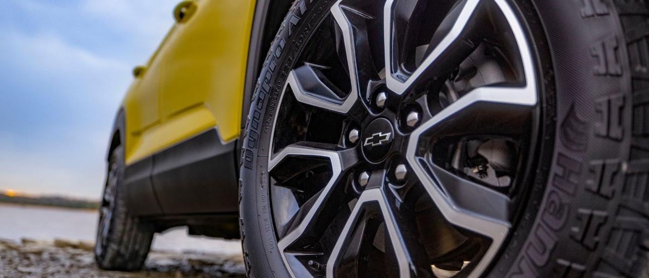 A close up shows a wheel on a yellow 2024 Chevy Trailblazer ACTIV.