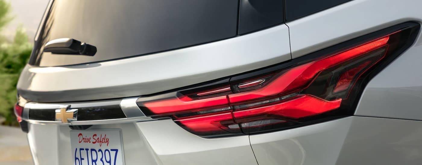 The rear of a silver 2023 Chevy Traverse.