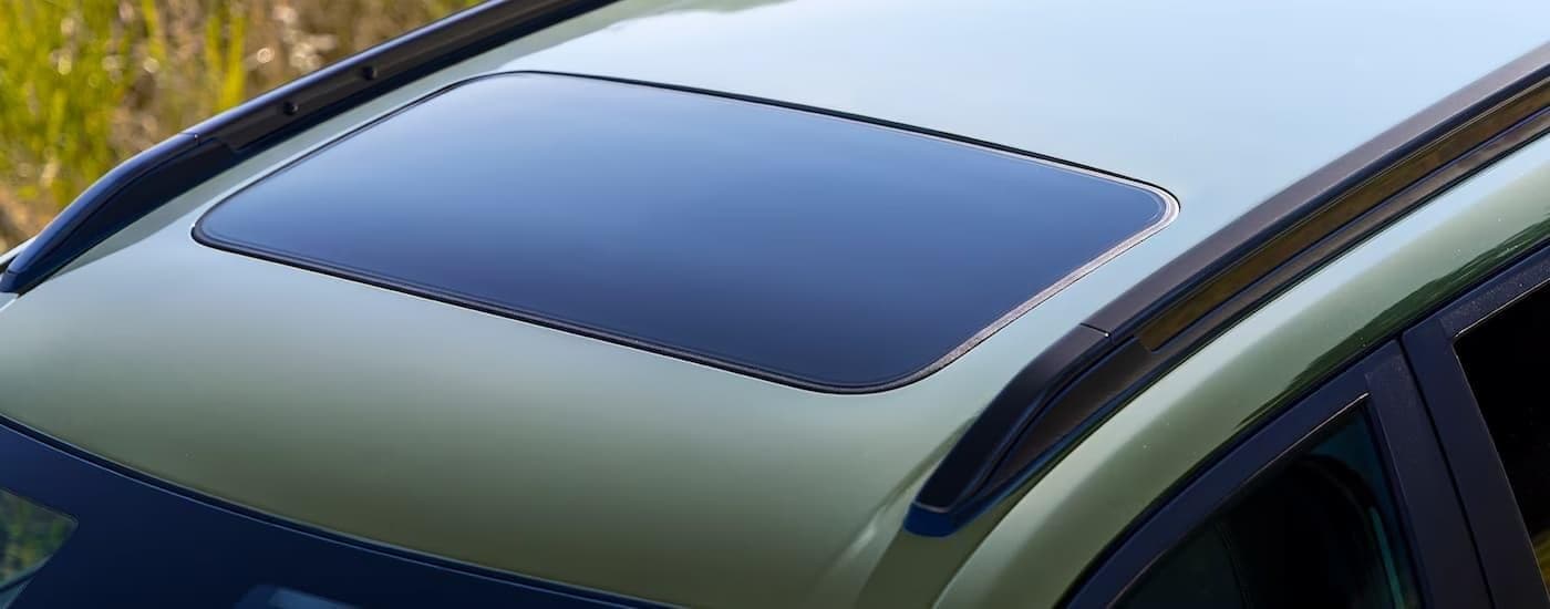 Close-up of the sunroof on a green 2024 Chevy Trax.
