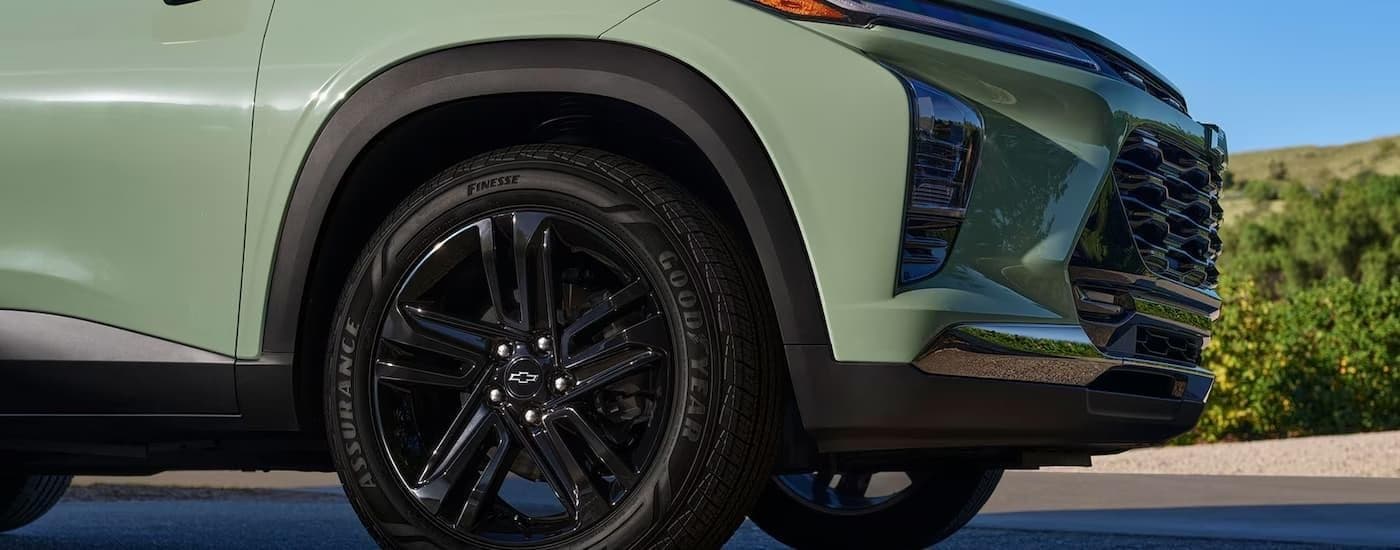 Close-up of the wheel on a green 2024 Chevy Trax.